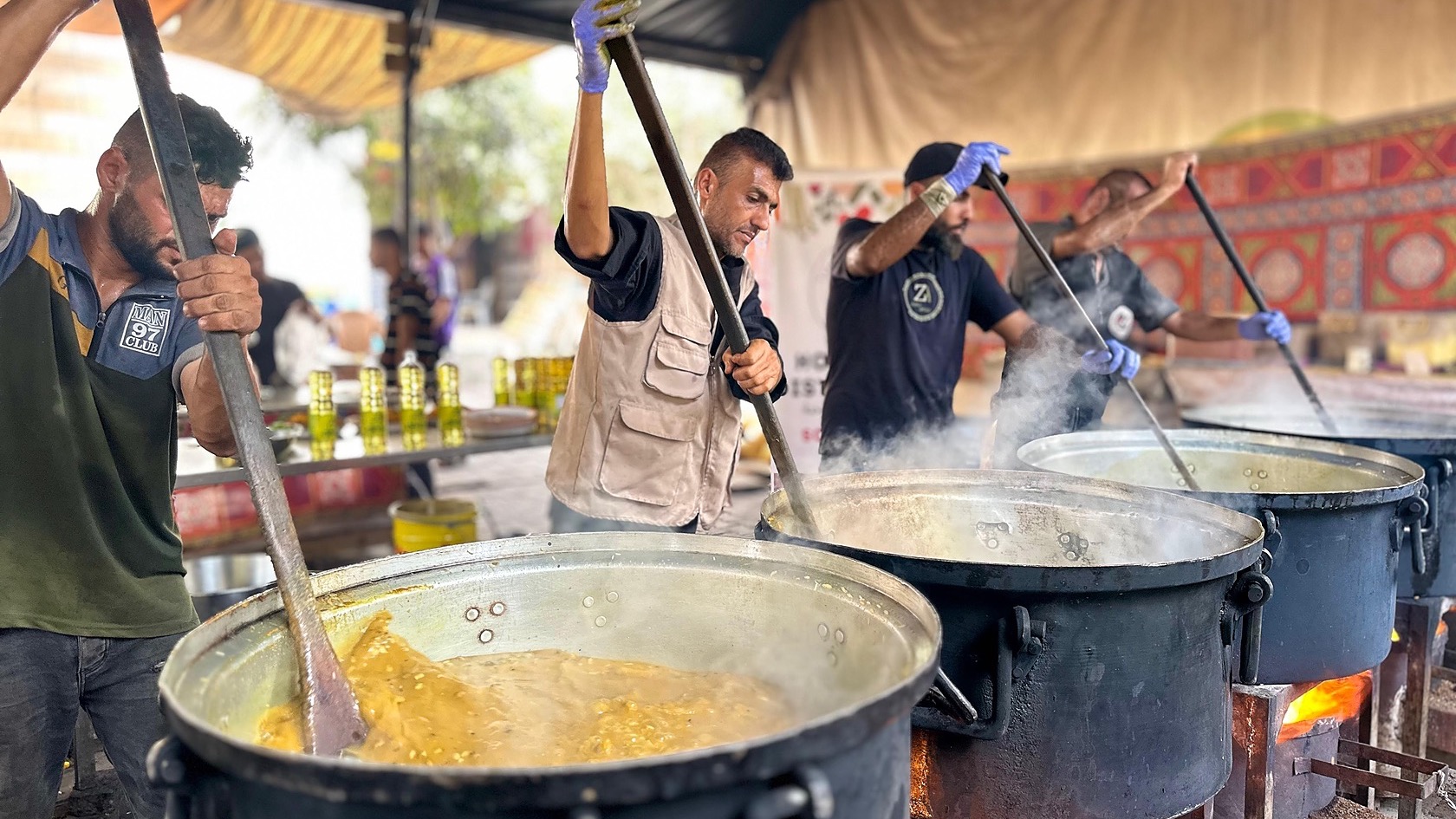 Zaynab Project ground-team members preparing food at large cooking pots